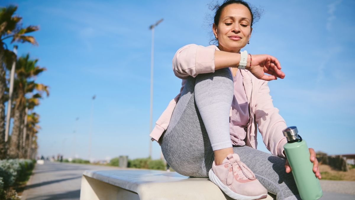 Woman checking sports watch during a workout