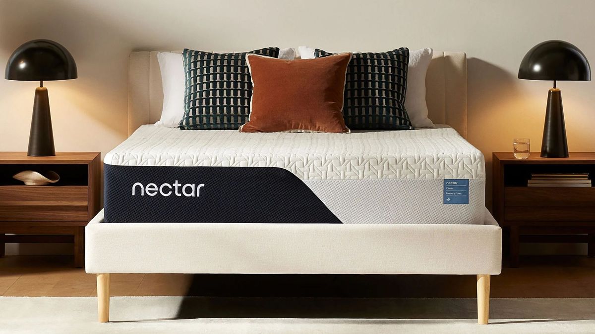 The image shows the Nectar Classic memory foam mattress on a white bed frame in a sleek and stylish bedroom