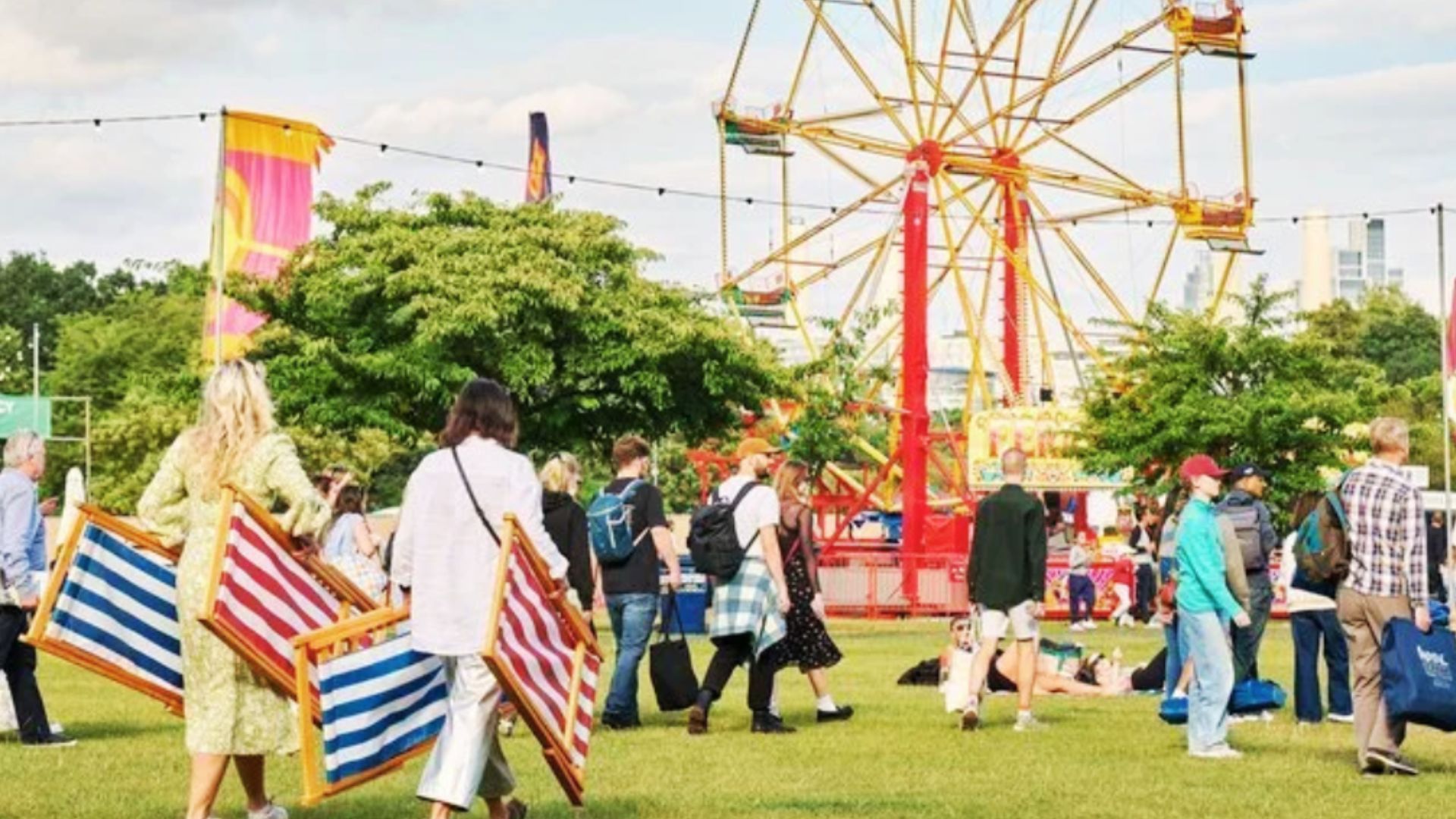 an image of festivalgoers heading into the festival carrying deck chairs