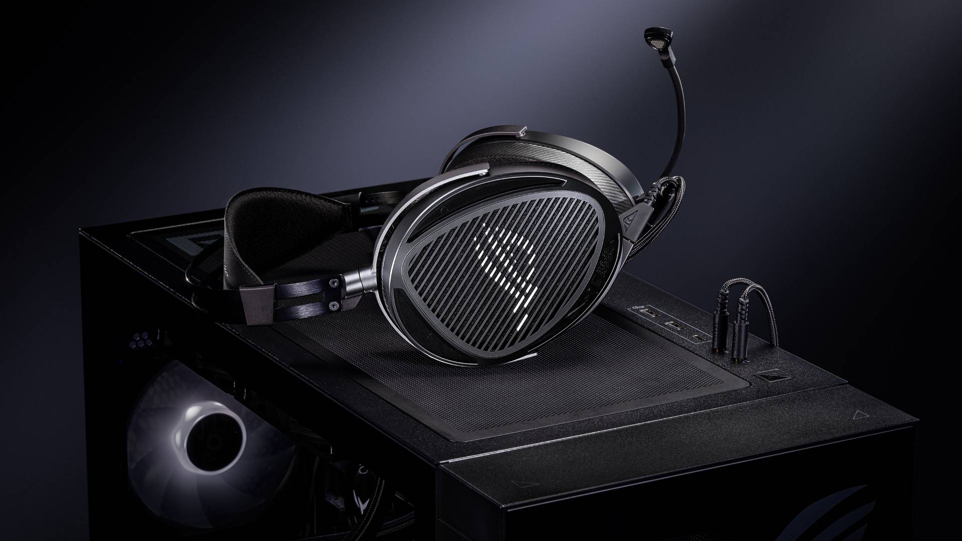 Official product image of the Asus ROG Kithara headset sitting on top of a black gaming PC.