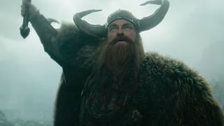 Gerard Butler, full viking attire, holding his sword high as Stoick the Vast, in the live-action adaptation of How to Train Your Dragon.