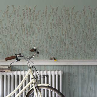 room with floral printed wallpaper and white bicycle