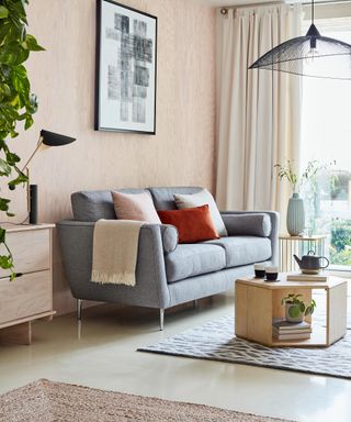 A Scandi-style living room with grey sofa and low pendant ceiling light