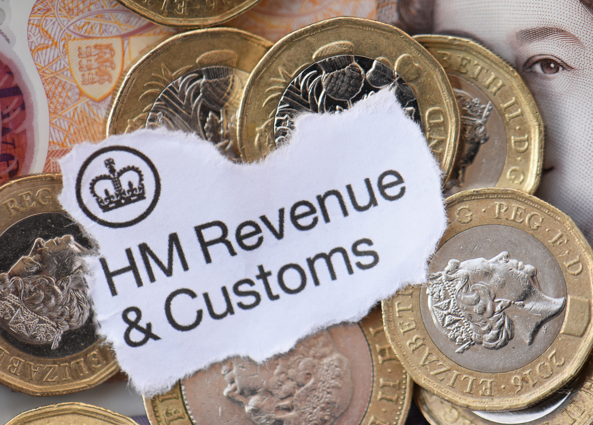 Pound coins under the lettering HMRC