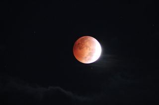 Scott Gauer captured this photo of the blood moon peaking through clouds in Pennsylvania on Oct. 8, 2014.