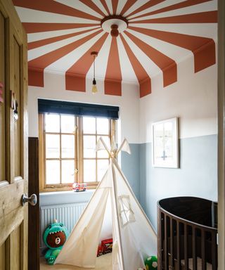 Kids' room paint ideas featuring a ceiling painted in red and white to look like a circus tent