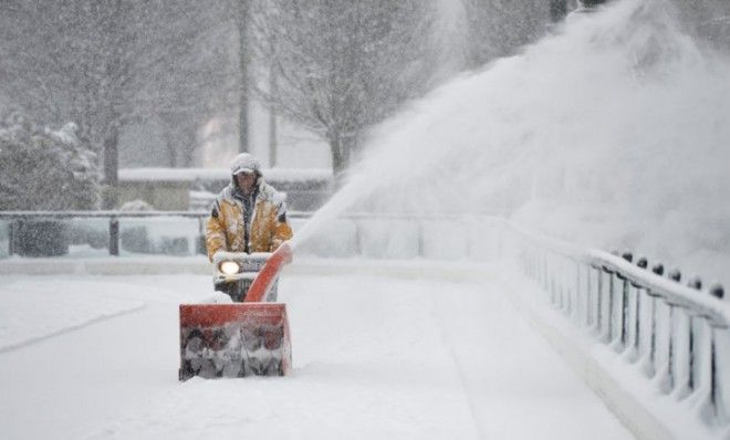 A man clears snow from Chicago&amp;#039;s Millennium Park skating rink on March 5.