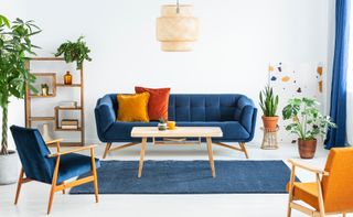 Blue sofa with orange cushions