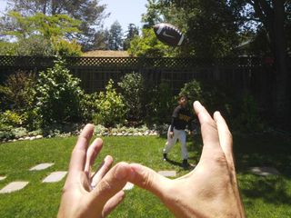 A view of a Google Glasses wearer about to catch a football.