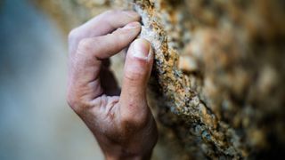 Close up of a climber's hand on the rock