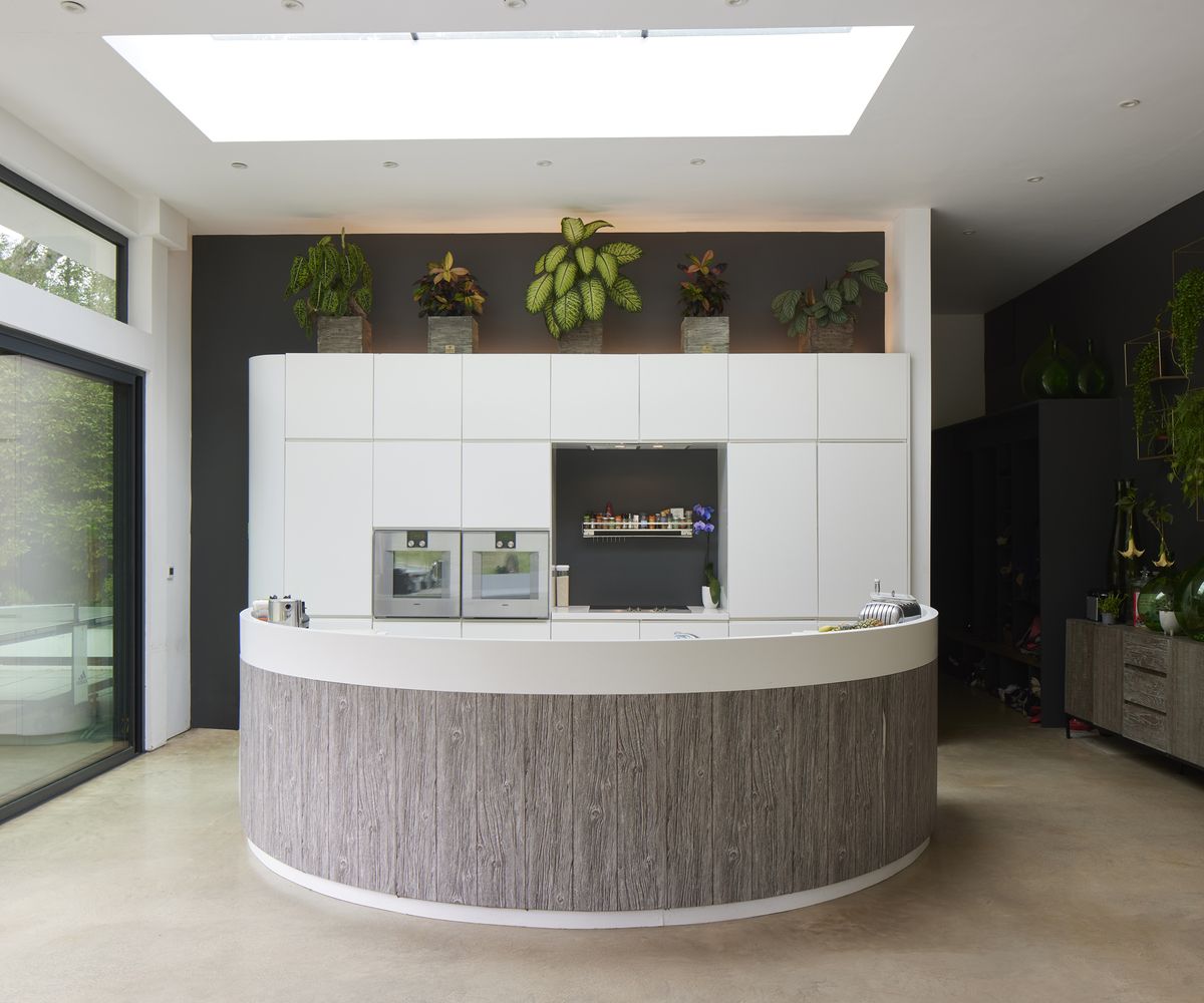 A curved kitchen island in modern self build kitchen