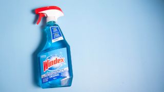 A bottle of Windex on a blue background