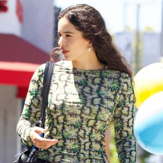 Rosalía wears a patterned green long-sleeve shirt on a lunch outing with Lisa from Blackpink 