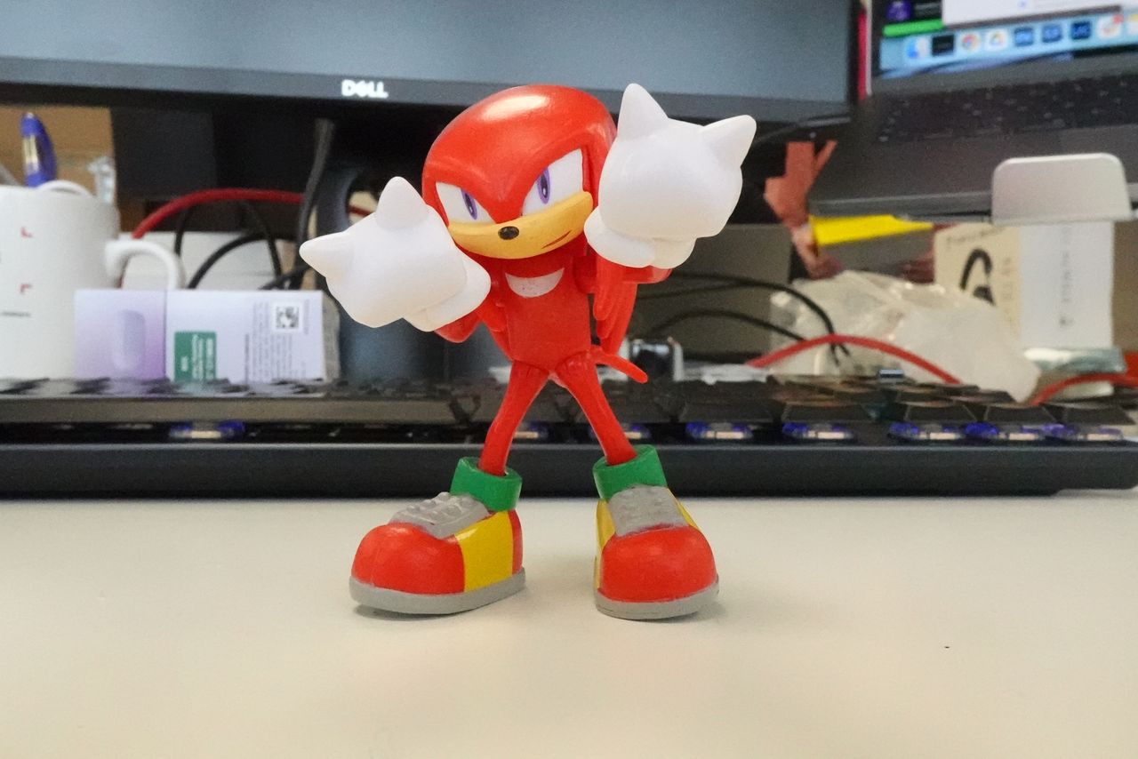 A photo of a red figurine taken on a Sony ZV-1F vlogging camera