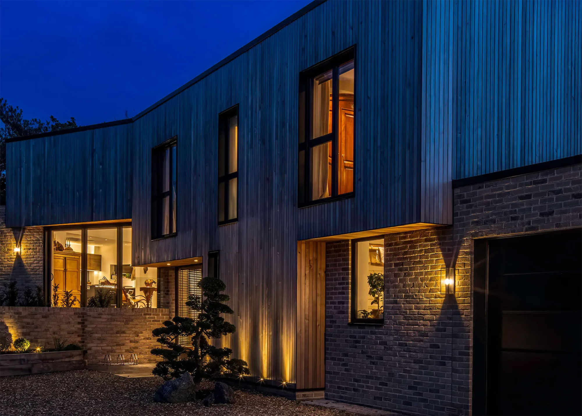 modern house with vertical timber cladding an architectural exterior lighting