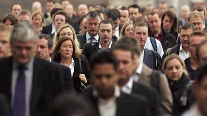 Commuters walk to work over London Bridge 