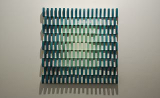 Rows of vertical green and blue lines on a canvas.