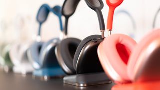 A number of AirPods Max lined up next to each other and in different colors.