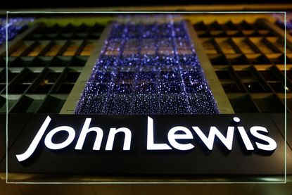 A John Lewis sign with Christmas lights above it