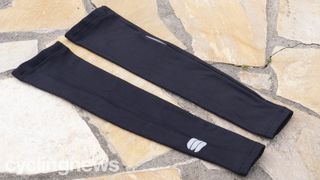 A pair of Sportful NoRain Arm warmers on a paved floor