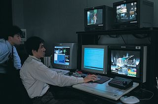 A person using CRT monitors.