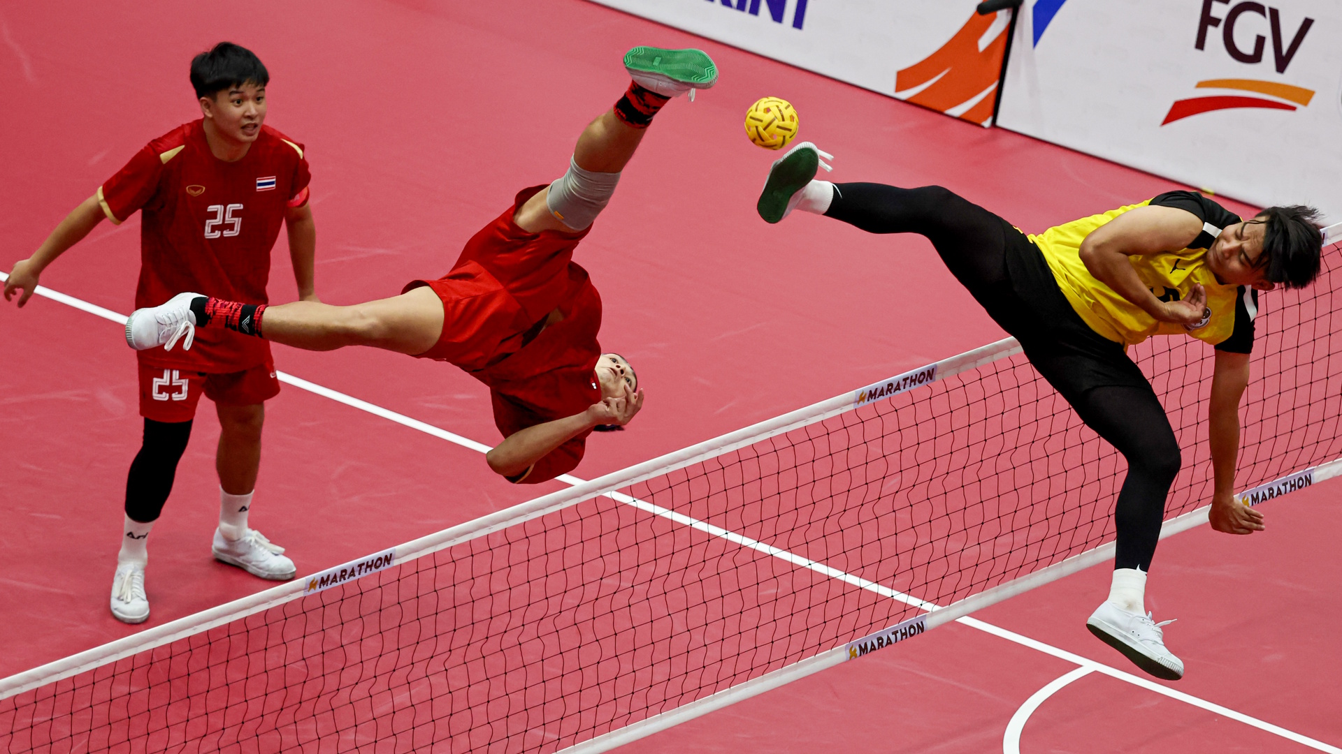 Action from a Sepak Takraw match between Thailand and Malaysia.
