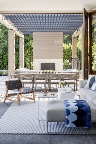 Pool house with bi fold doors to open up the sides and blue and white decor