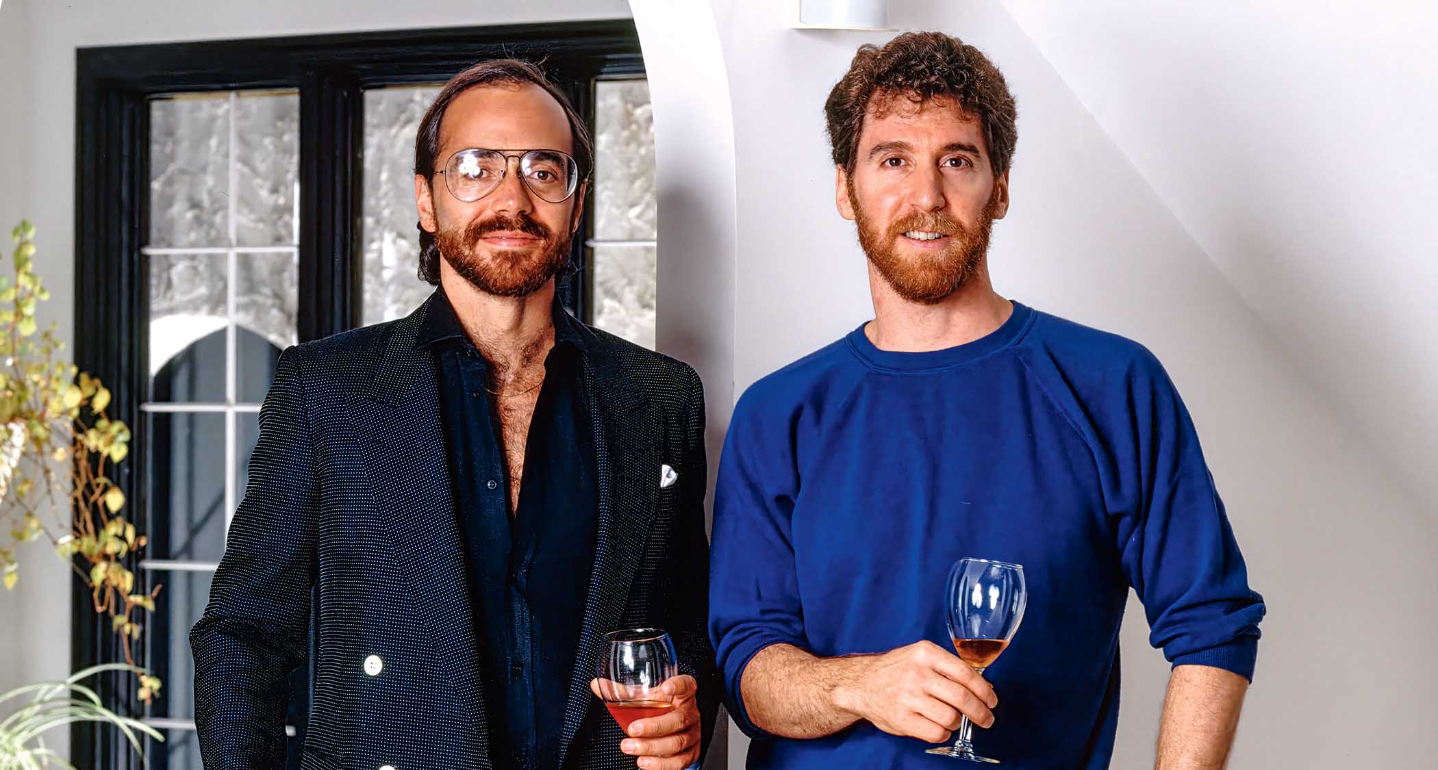 Al Di Meola and Larry DiMarzio toast their partnership with a glass of wine.