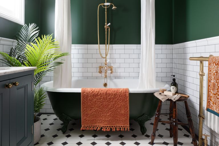 Family bathroom with green rolltop bath and green walls