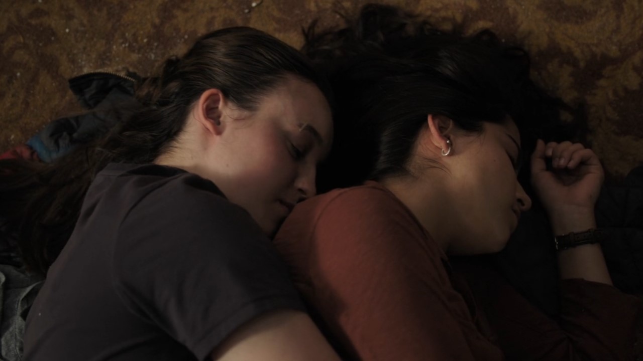 Bella Ramsey as Ellie and Isabela Merced as Dina on The Last of Us.