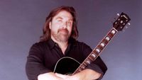 Dennis Locorriere with an acoustic guitar