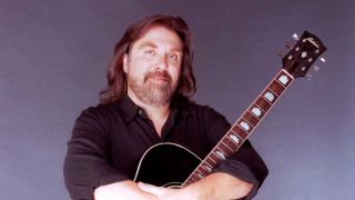 Dennis Locorriere with an acoustic guitar