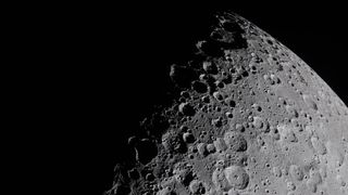the cratered surface of the moon on a black background
