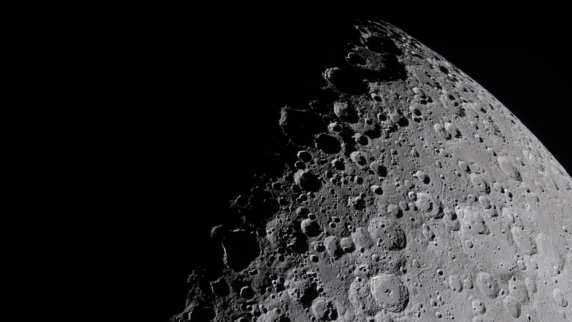 the cratered surface of the moon on a black background