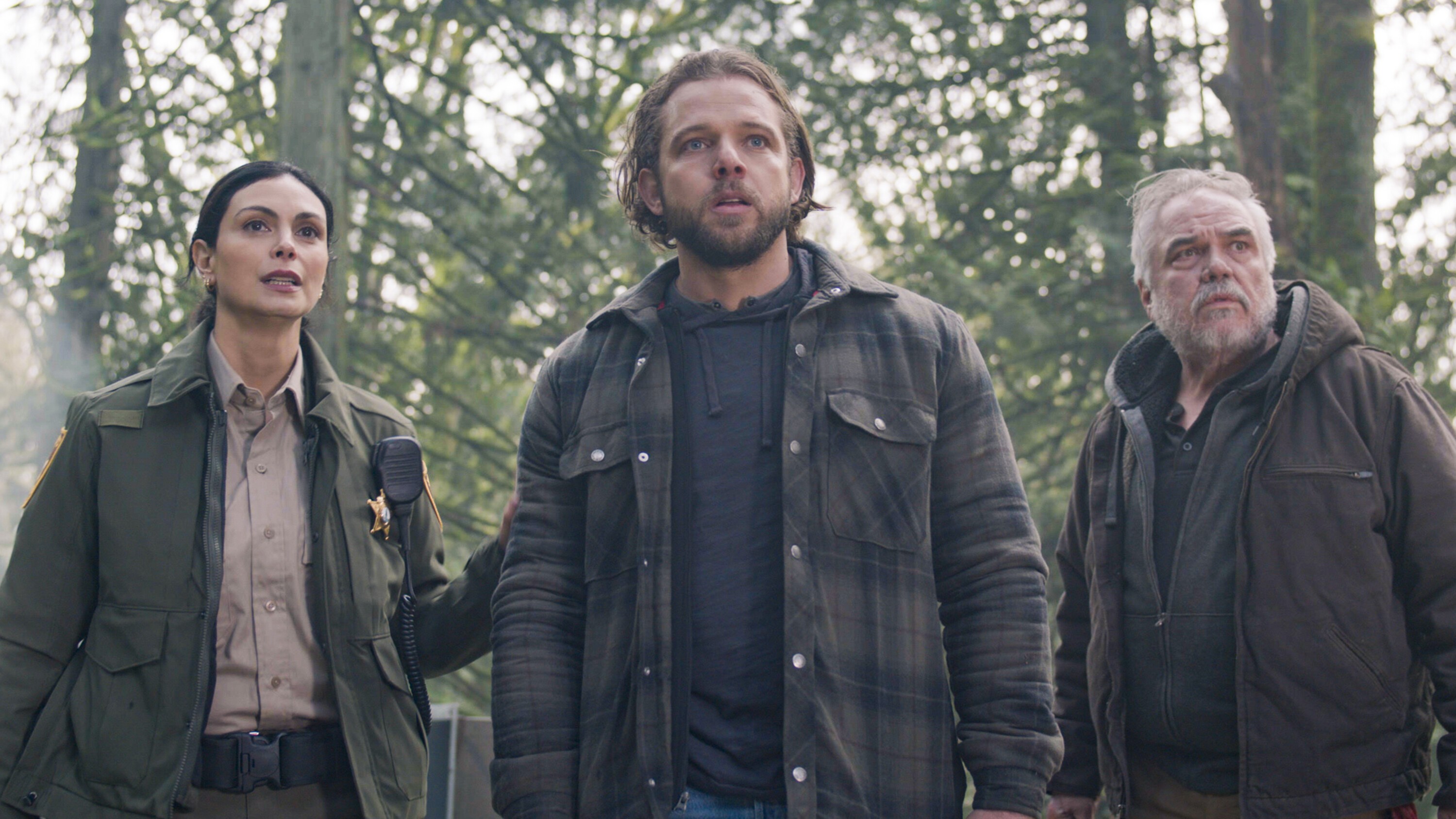 Morena Baccarin as Sheriff Mickey Fox, Max Thieriot as Bode Leone and W. Earl Brown as Wes Fox in the woods in Sheriff Country