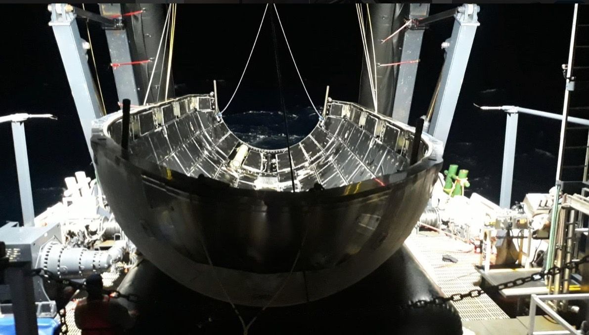 Half of the payload fairing that protected the Arabsat-6A satellite during the second-ever launch of SpaceX&#039;s Falcon Heavy rocket sits on a recovery ship on April 11, 2019.