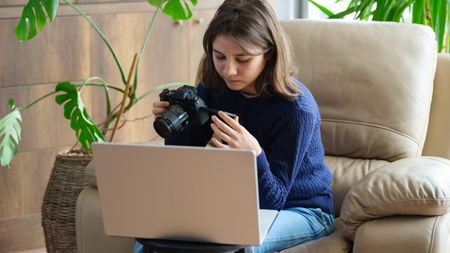 Teenager with camera and laptop