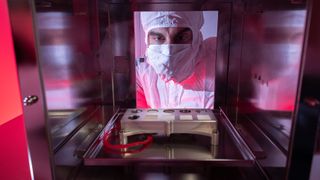 A member of the Mars 2020 Science Team looks at the calibration target that will be sent on the Mars rover, Perseverance, including SaU 008.