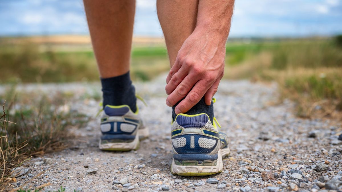 Man holding achilles tendon