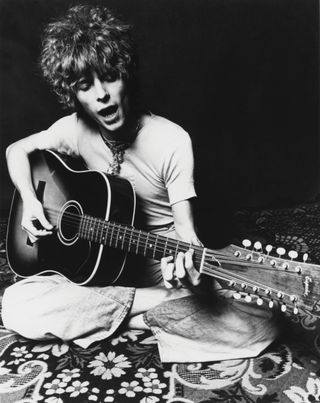 Bowie with his 12-string guitar in a promo shot for Space Oddity, 1969