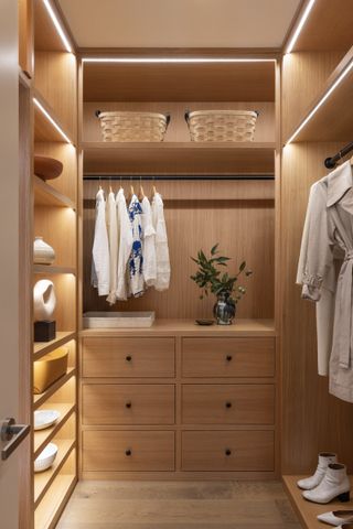 White Arrow Quay Tower Apartment walk in wardrobe with wicker detailing