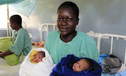 Millicent Owuor, 20, carries her newborn twin boys Barack (left) and Mitt (right).