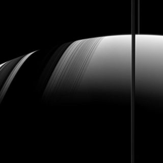 Shadows of Saturn's rings (right) fall across the planet at left.