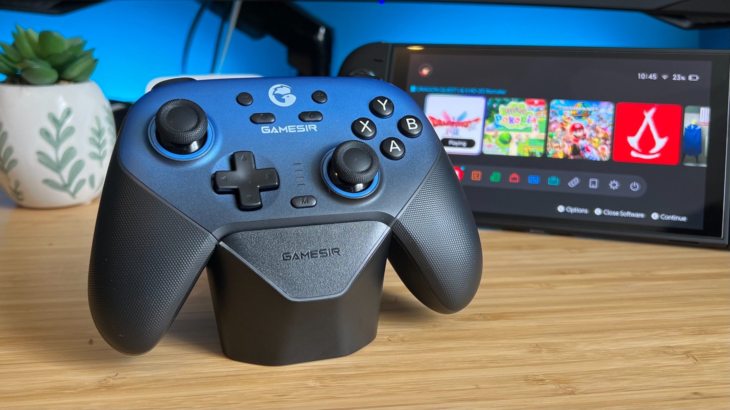 GameSir Super Nova controller on a charging dock in front of a Nintendo Switch 2 handheld
