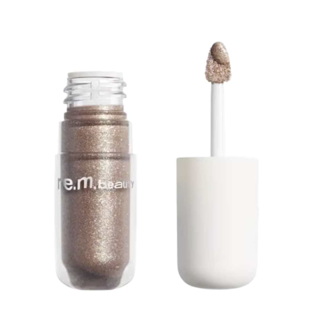 A product shot of the REM BEAUTY Starlet Liquid Eyeshadows in Shade Horoscope (a shimmery taupe-brown), on a white background