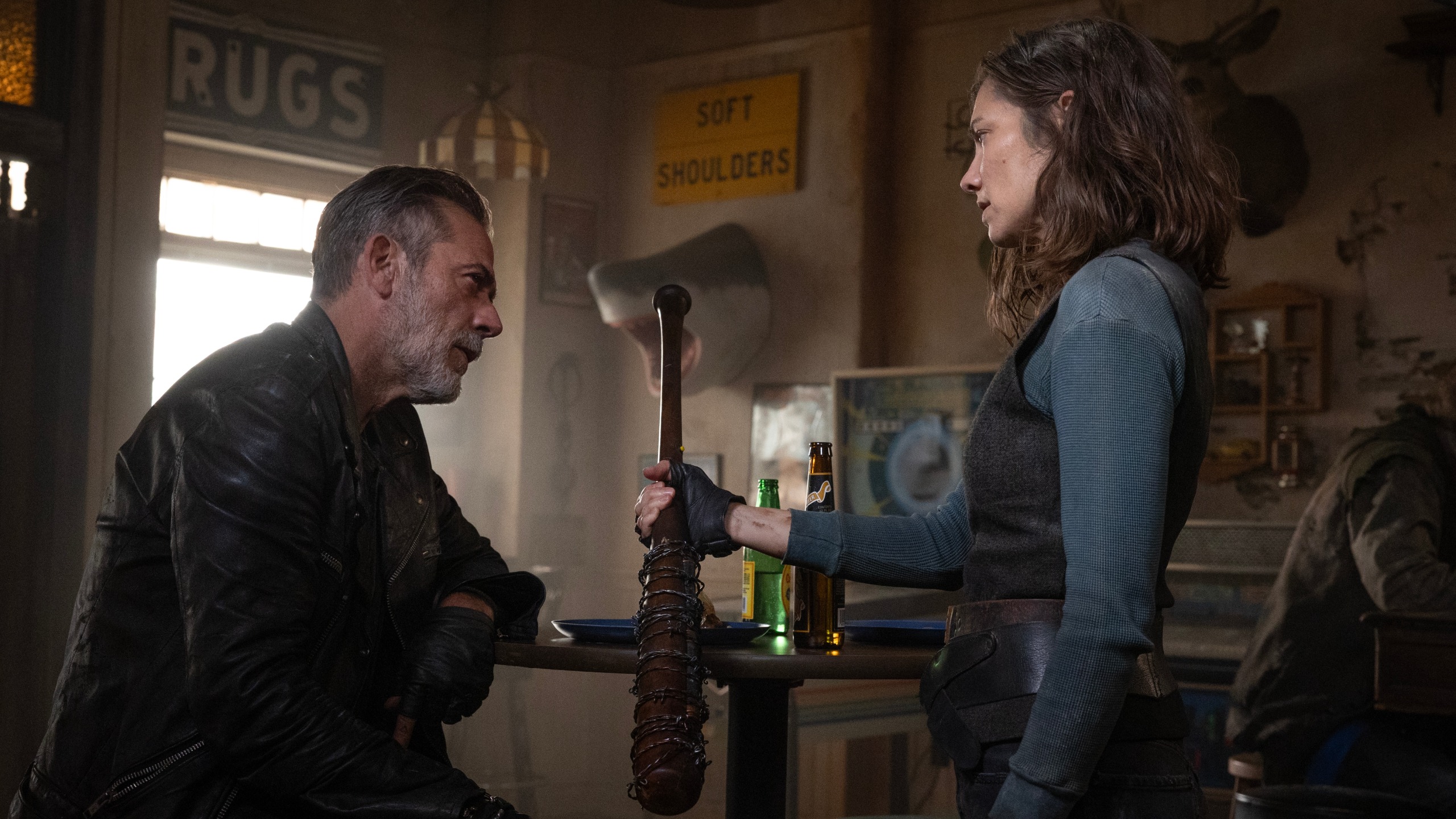 Maggie (Lauren Cohan) giving Negan (Jeffrey Dean Morgan) a baseball bat wrapped in barbed wire.