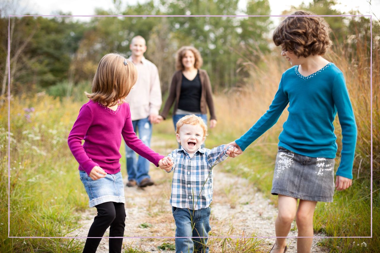 parents holding hands with three kids holding hands in front