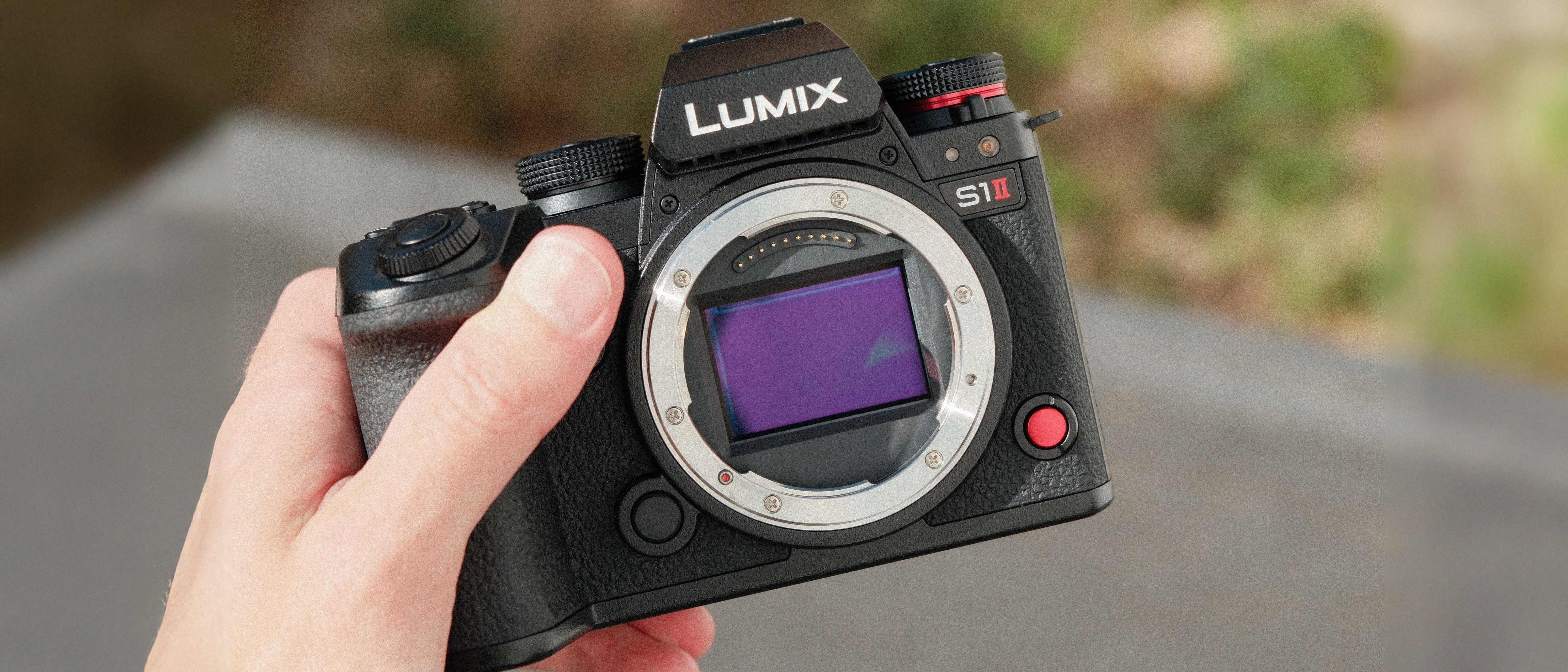 Panasonic Lumix S1 II camera held in a hand
