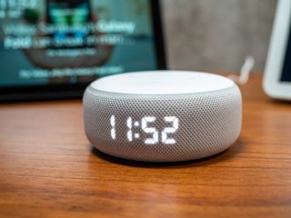 Echo Dot with Clock on side table