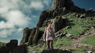 Rey walks down one of Ahch-To's many rocky islands in Star Wars: The Last Jedi